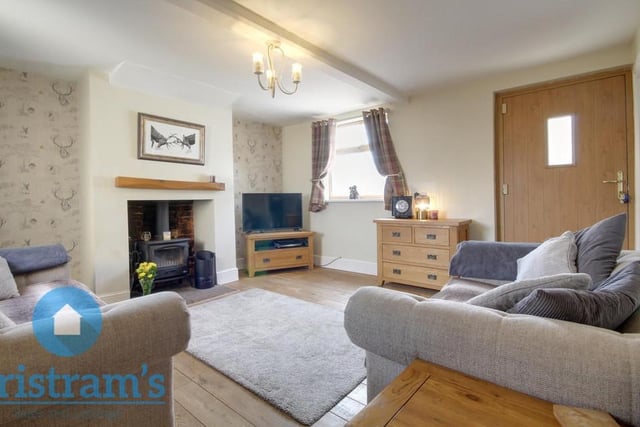 The living room lends itself to cosy nights in, watching the telly, in front of a nice, warm fire. The flooring is wooden and there is a ceiling light fitting available.