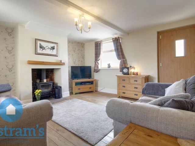 The living room lends itself to cosy nights in, watching the telly, in front of a nice, warm fire. The flooring is wooden and there is a ceiling light fitting available.
