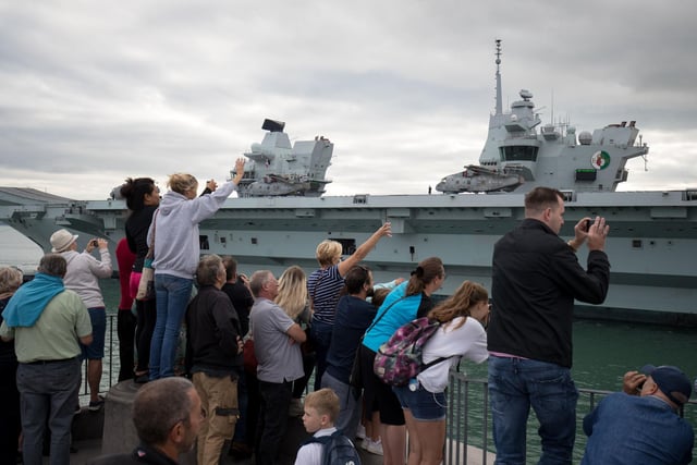 People wave from the Round Tower in Old Portsmouth as HMS Queen Elizabeth leaves. Picture: Andrew Matthews/PA Wire