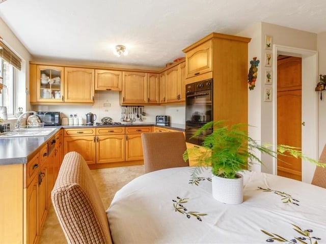 The impeccably presented kitchen includes space for a breakfast table. There is also an inset one-and-a-half sink with drainer and mixer tap.