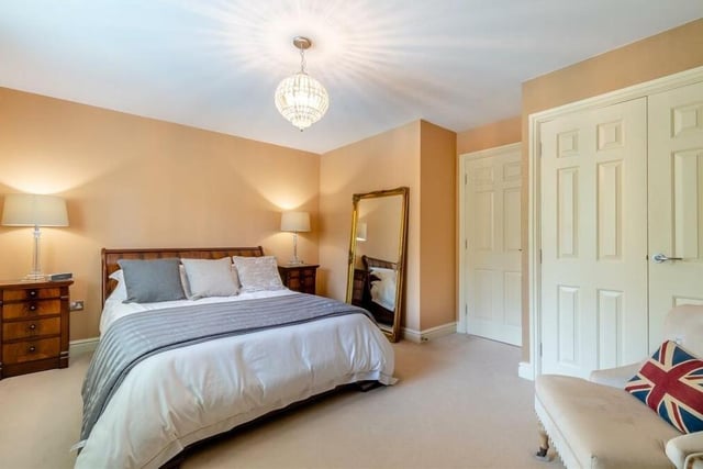 Extensive fitted wardrobes are a feature of this attractive bedroom at The Dell.