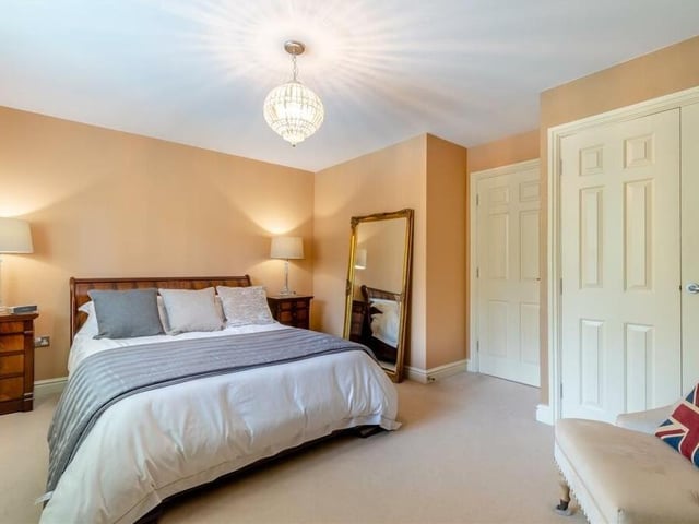 Extensive fitted wardrobes are a feature of this attractive bedroom at The Dell.