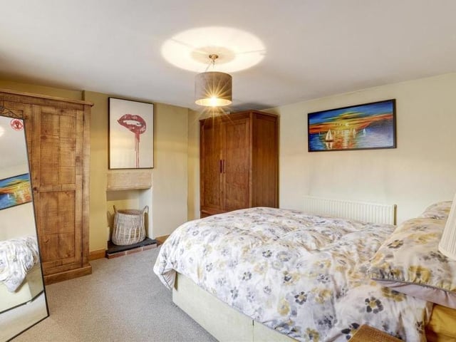 Time to move upstairs now at the Linby cottage. This is the first bedroom, which has a recessed chimney-breast alcove, complete with tiled hearth. There is space for wardrobes and furniture.