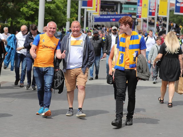 Mansfield Town fans watch the drama unfold inside Wembley.