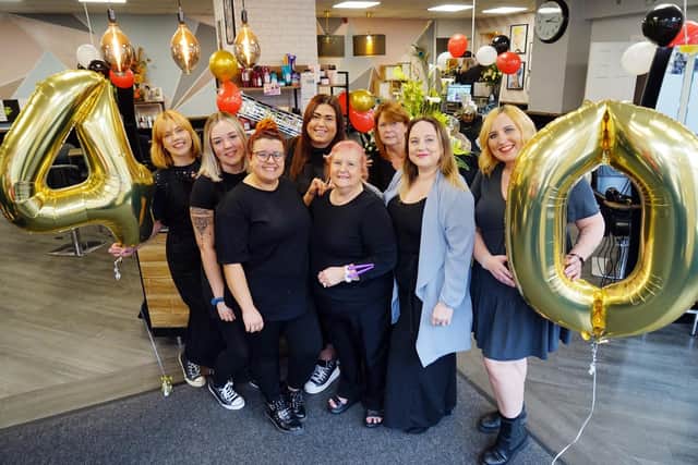 Staff celebrating the Friends Hair Company's 40th birthday.