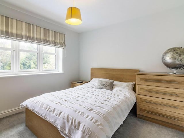 This bedroom offers scenic views of the Bagthorpe property's green surroundings.