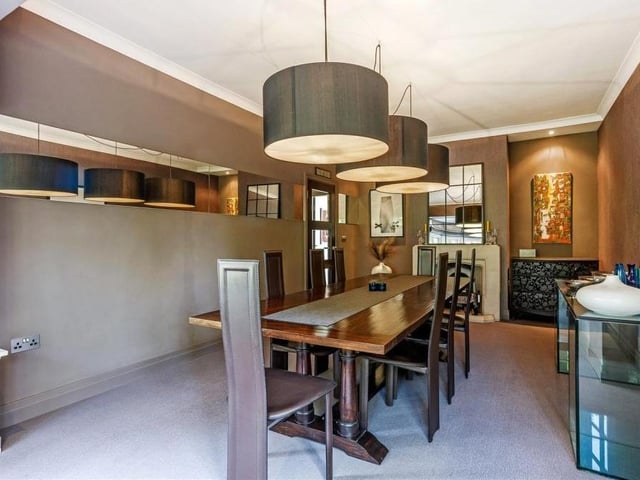 The dining room at the Roebuck Drive house is spacious and light. Featuring a silk wall, fireplace and bay-fronted window facing the front of the property, it is the ideal spot for entertaining family and friends.
