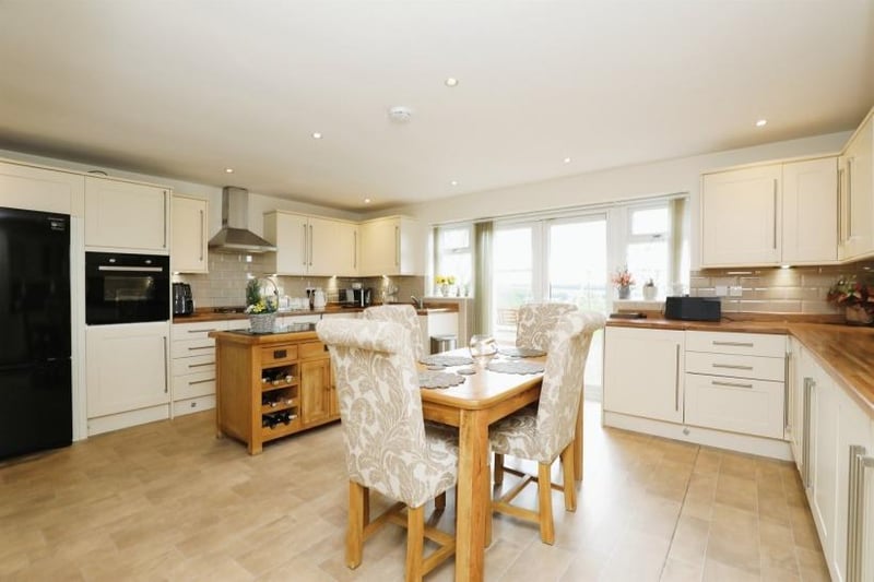A spacious dining kitchen within the newly-built bungalow at the estate. It boasts an integrated oven, dishwasher and washer dryer, while French doors take you out on to the rear patio