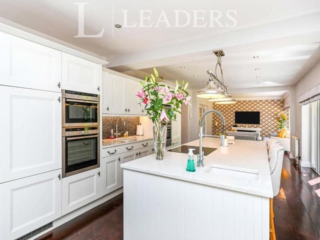 The open-plan kitchen cannot be faulted. Appliances, mostly by Neff, include a built-in steam and combination oven, a double oven, a microwave, coffee machine, fridge freezer, dishwasher and warming drawer. A large central island, with quartz work surface over, includes a built-in wine cooler and induction hob.