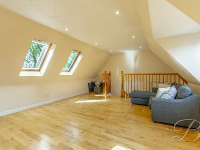 Bedroom number two is accessed via a short flight of stairs. Spacious, with dual-aspect windows to the front and side and also two Velux windows, it is blessed with laminate flooring and downlights.