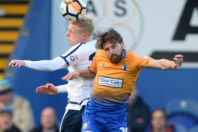 MANSFIELD, ENGLAND - DECEMBER 03: Darren Holden of Guiseley and Paul Anderson of Mansfield Town in action during The Emirates FA Cup Second Round match between Mansfield Town and Guiseley at One Call Stadium on December 3, 2017 in Mansfield, England. (Photo by Nathan Stirk/Getty Images)