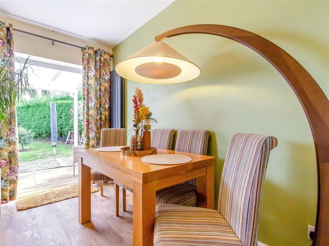 The delightful dining section of the lounge/diner is bright and cheerful, with views of the garden.