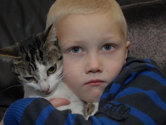 Young Jack Martins with his cat Lily.