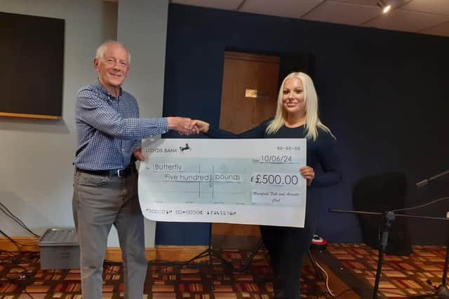 Dave Kemp chair of Mansfield Folk and Acoustic Club presenting a cheque to Jordan Cotton from the Butterfly charity
