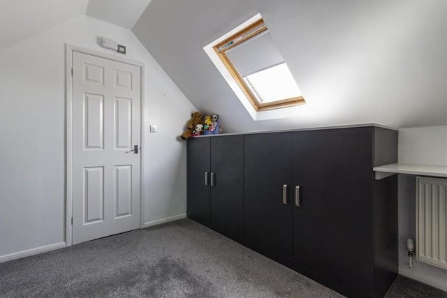 Here is the fourth and final bedroom. It includes two fitted base units and a door that leads to an en suite room.