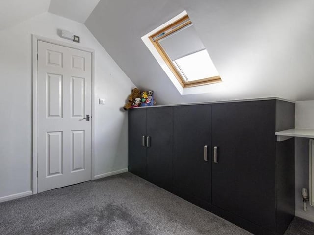 Here is the fourth and final bedroom. It includes two fitted base units and a door that leads to an en suite room.
