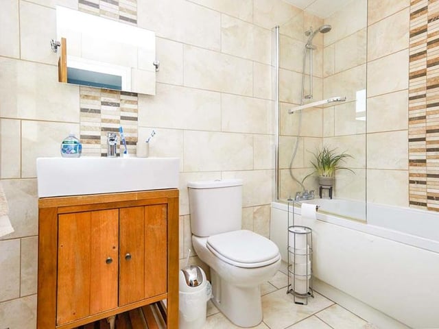 The family bathroom can also be found on the first floor. Recently upgraded and well presented, it is a modern room consisting of a panelled bath with shower over, a modern vanity unit with inset sink and a low-flush WC. The walls and floor are tiled.