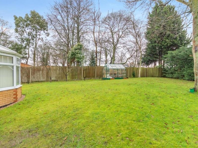 In total, the L-shaped rear garden extends to 0.12 of an acre -- quite a size! This photo shows how the conservatory (left) also opens out on to it.