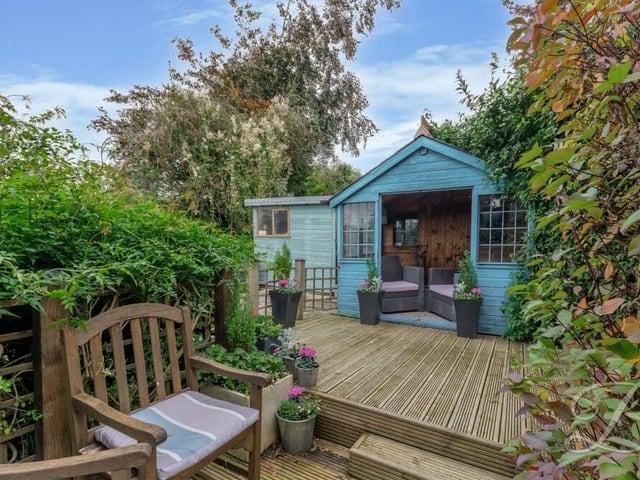 Outbuildings within the garden include greenhouses, a shed and this delightful summer house that is a heavenly retreat on a warm day.