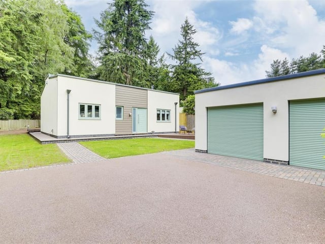 Moving outside now, and this image captures the environmentally-friendly double garage, which is fitted with solar panels and is accessed by electric roller doors.