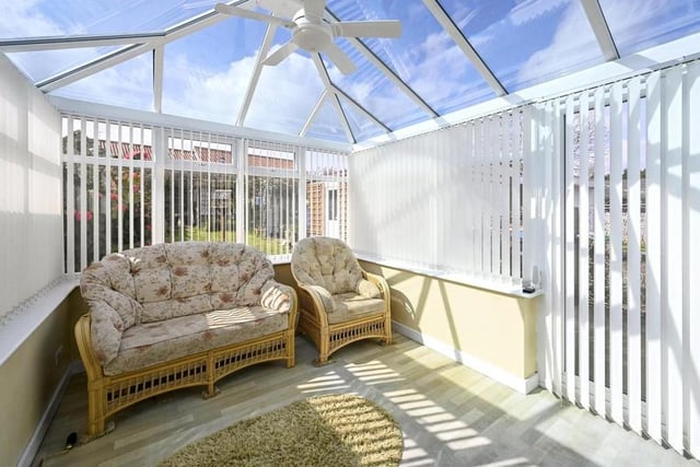 And here is that conservatory, which is bonny and bright. French doors lead out to the garden.
