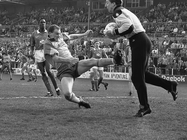 This is going to hurt! A typical full-on Phil Stant challenge on the Carlisle United keeper.
