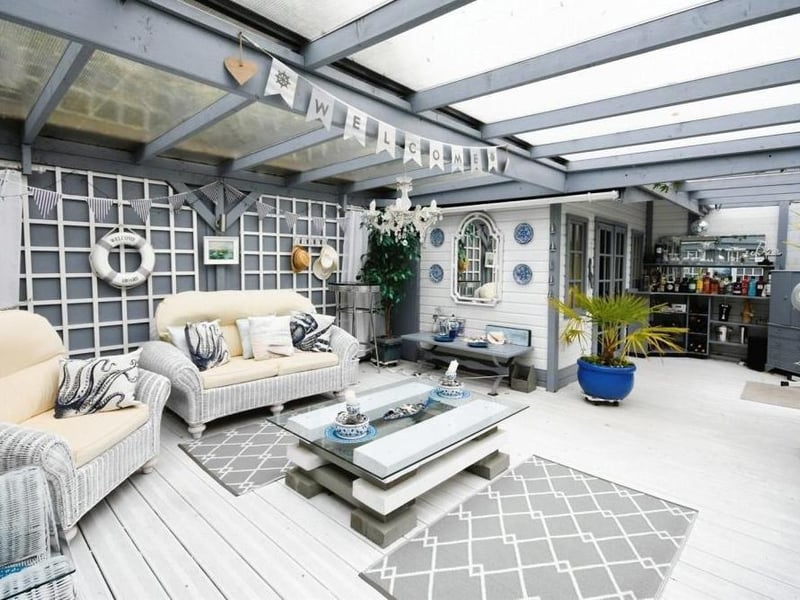 This second look at the interior of the summer house shows the bar. Whose round is it?
