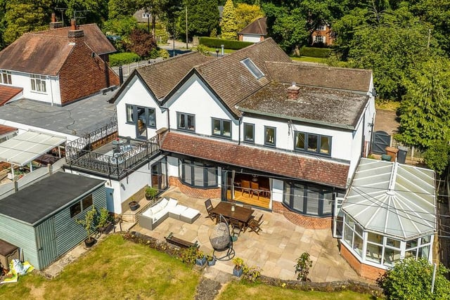 This drone shot provides a superb overview of the back of the £795,000 Ravenshead property, capturing the bedroom balcony and the large patio area, as well as the greenhouse and garden shed.