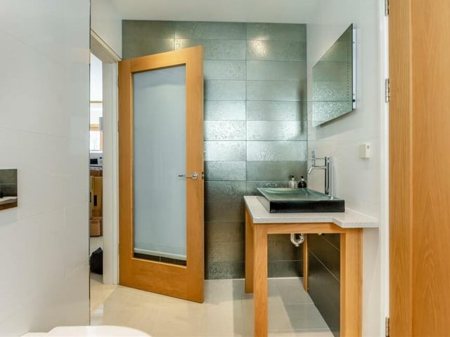 A second look at the Jack and Jill wet room, which comes complete with a solid-glass Kohler sink and mixer tap. Above is a heated and lit motion sensor mirror.