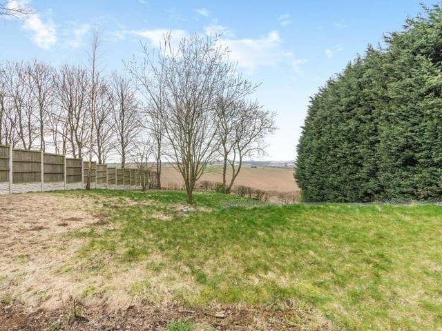 The extensive back garden at the property also features grassed areas and established trees.