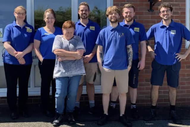 Jane Holt and Jordan Lee, pictured with the Mansfield branch of staff and volunteers.