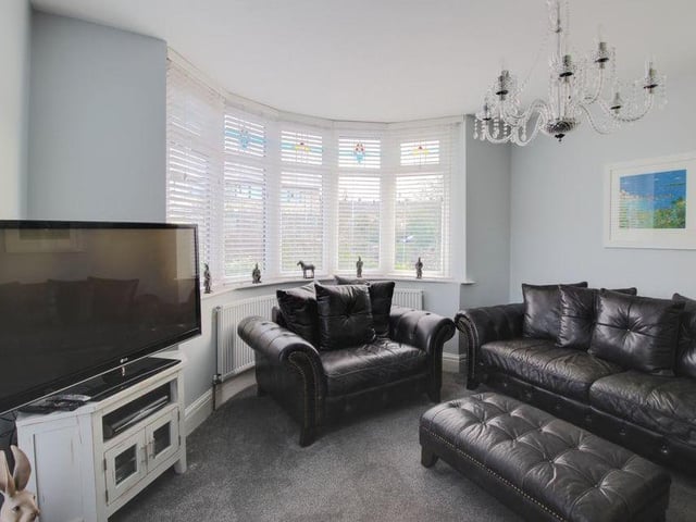 Opposite the kitchen sits this lovely lounge, which is the ideal place to spend a relaxing evening in front of the telly. It has a feature bay window and garden views.