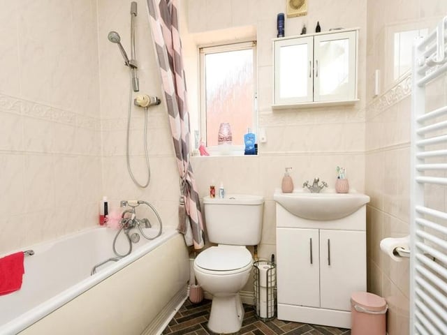 Here is the family bathroom, complete with bath and shower over, hand wash basin, vanity unit, low-flush WC and heated towel-rail.