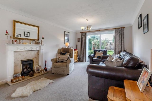 As befits the main living area of the house, the large lounge boasts a feature fireplace. A coal-effect gas fire has a marble hearth and an Adam-style surround.