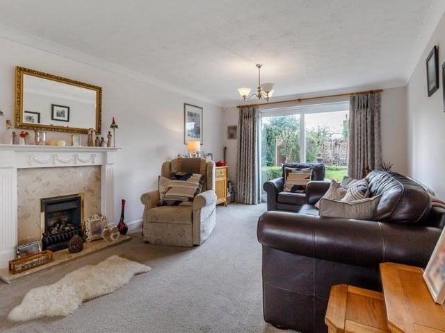 As befits the main living area of the house, the large lounge boasts a feature fireplace. A coal-effect gas fire has a marble hearth and an Adam-style surround.