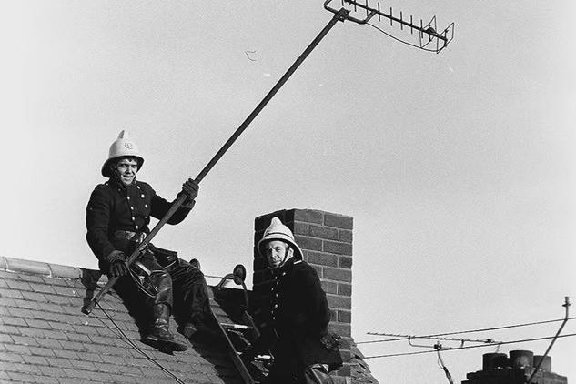 Emergency services secure TV aerials that were ripped from the rooftops in 1976.