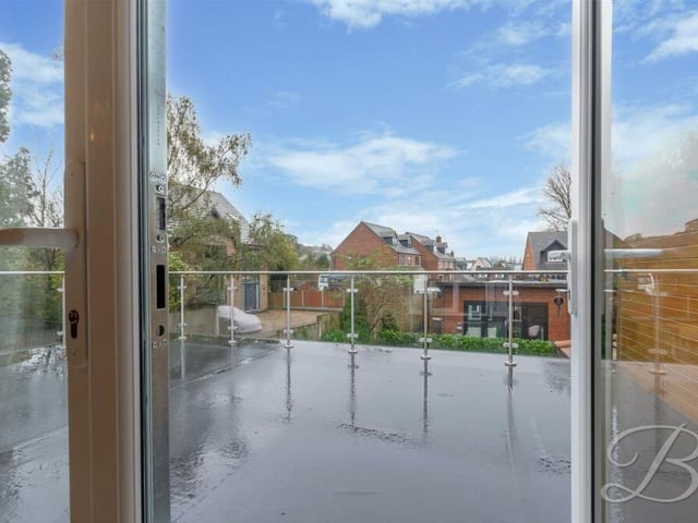 The bedroom balcony offers views of the back garden at the Hillsway Crescent property.