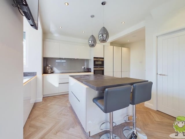 A close-up of the central island in the kitchen, with room for seating at one end.