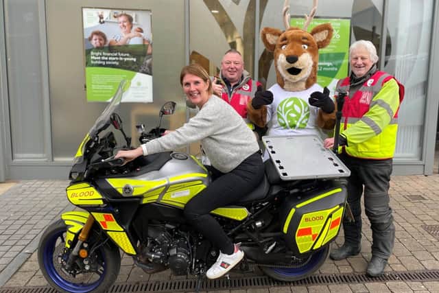 Society mascot, Stanley, with Blood Bike volunteers and their new bike, now named Stanley.