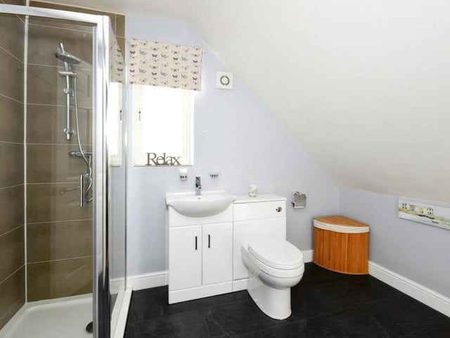 Here is the en suite to the master bedroom. It comprises a corner shower cubicle, vanity unit, wash hand basin and low-flush WC.