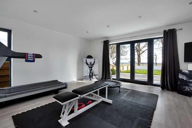 Currently utilised as a home gym, the room boasts underfloor heating and French doors leading out onto the front.