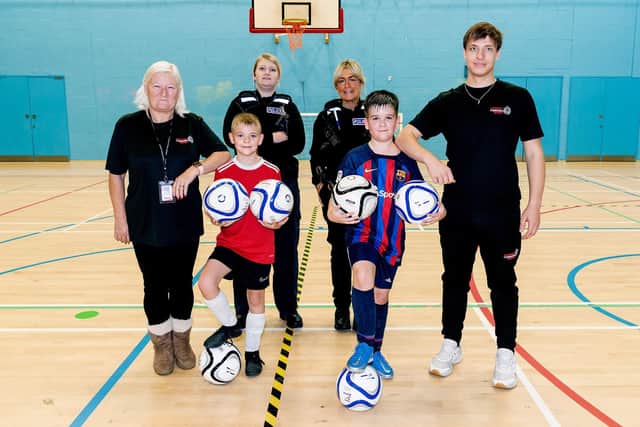 Executive administrator of Support Through Sport Angela Pickard, PC Vesta Daukintyte, Harley and Alex, both 10, PC Liz Spencer-Creed and sports coordinator Norbert Kruszynski.