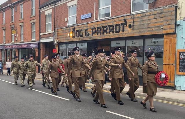 Soldiers march past the Dog and Parrot during the town's Remembrance Sunday parade.