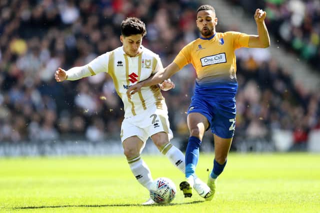 CJ Hamilton of Mansfield Town battles for possession with George Williams of Milton Keynes Dons during the Sky Bet League Two match between Milton Keynes Dons and Mansfield Town at Stadium mk on May 04, 2019 (Photo by Bryn Lennon/Getty Images)