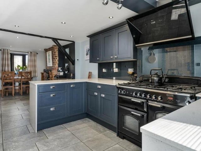 This photo shows how the classy kitchen flows seamlessly into the dining room at Lea Cottage.