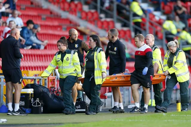Alfie Kilgour is stretchered off in the 2-2 draw at Doncaster last week with a ruptured Achilles that has ended his season. Photo by Chris & Jeanette Holloway/The Bigger Picture.media.
