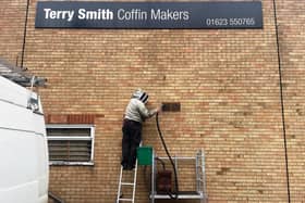 The nest of honey bees being taken from a wall outside of Terry Smiths coffin factory, in Nottingham.