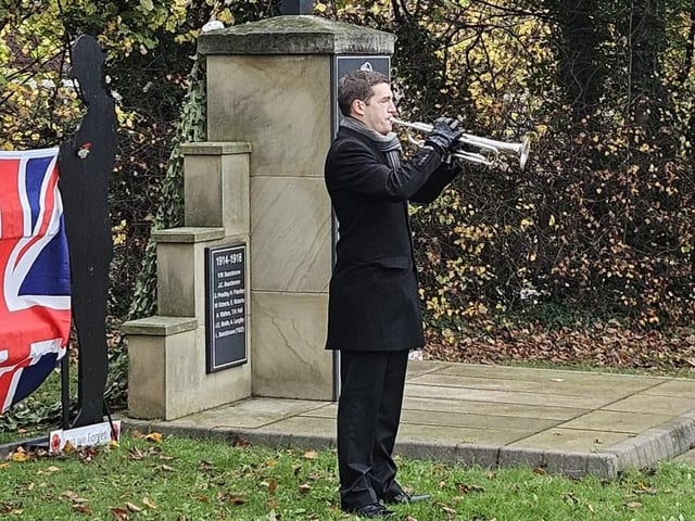A trumpeter plays The Last Post at Nuthall war memorial.