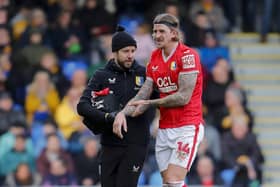 Mansfield Town defender Aden Flint (14) is injured during the Sky Bet League 2 match against AFC Wimbledon at Cherry Red Records Stadium, 27 Jan 2024 
Photo Chris & Jeanette Holloway / The Bigger Picture.media
