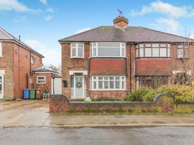 The property stands back from the road behind a low walled frontage. There is a driveway adjacent to a front garden laid to lawn. A door to the side of the house provides access to an enclosed outbuilding storage area with access to two stores, one with plumbing for a washing machine, and a door at the end leads through to the rear garden.